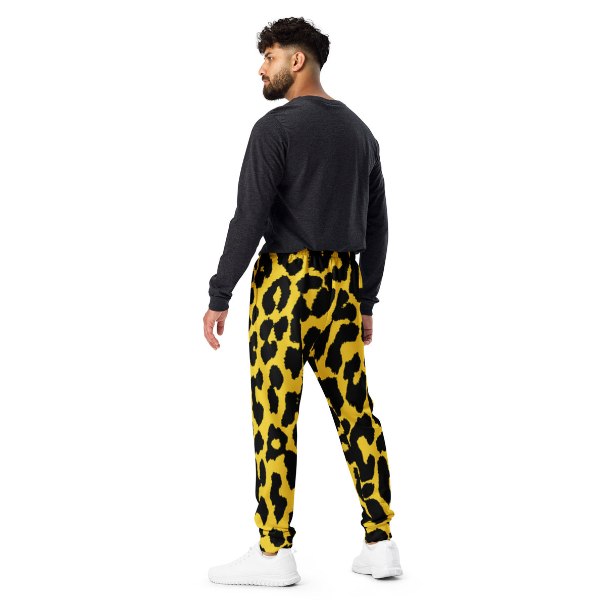 Men's leopard print joggers with yellow base and black spots, side view of tapered legs