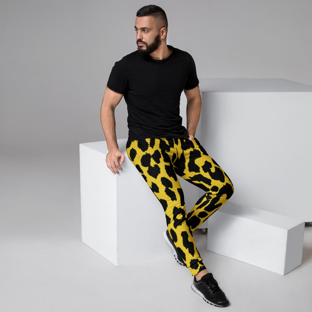 Leopard print men's joggers with yellow base, black spots, tapered fit and ankle cuffs