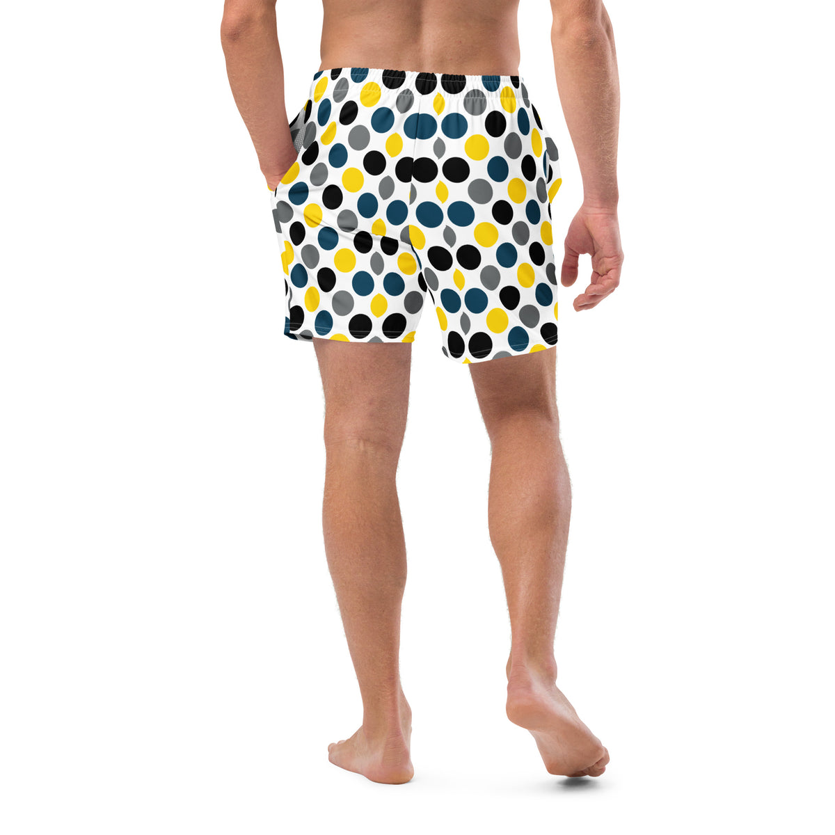 Polka dot swim trunks in white with blue, yellow, and black dots, mid-length