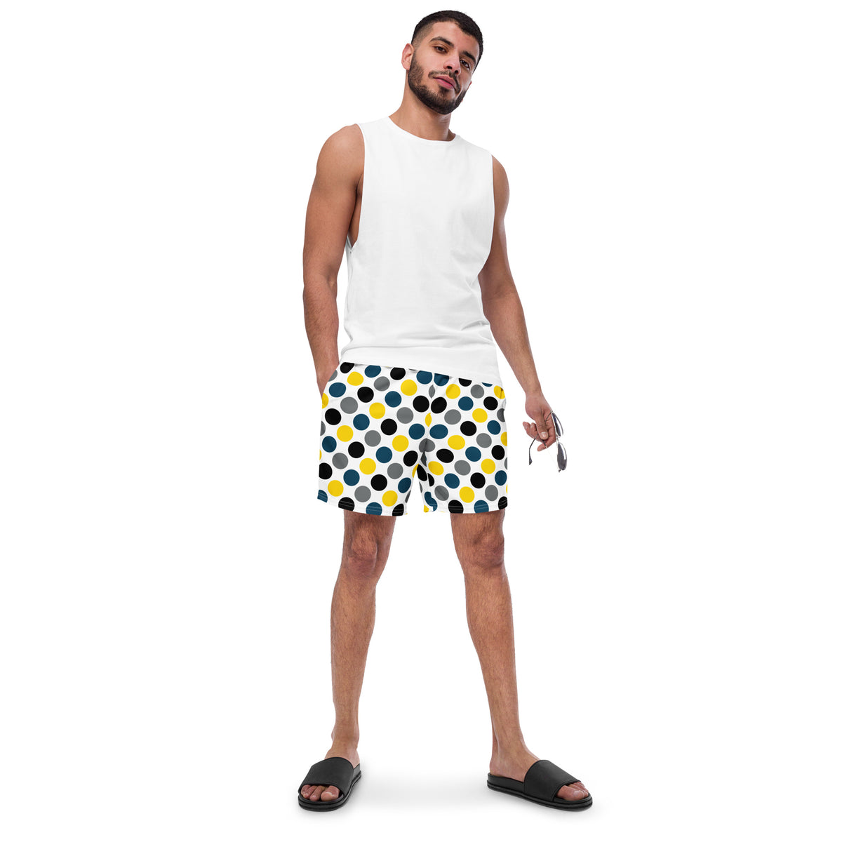 Polka dot swim trunks in white with blue, yellow, and black dots, mid-length