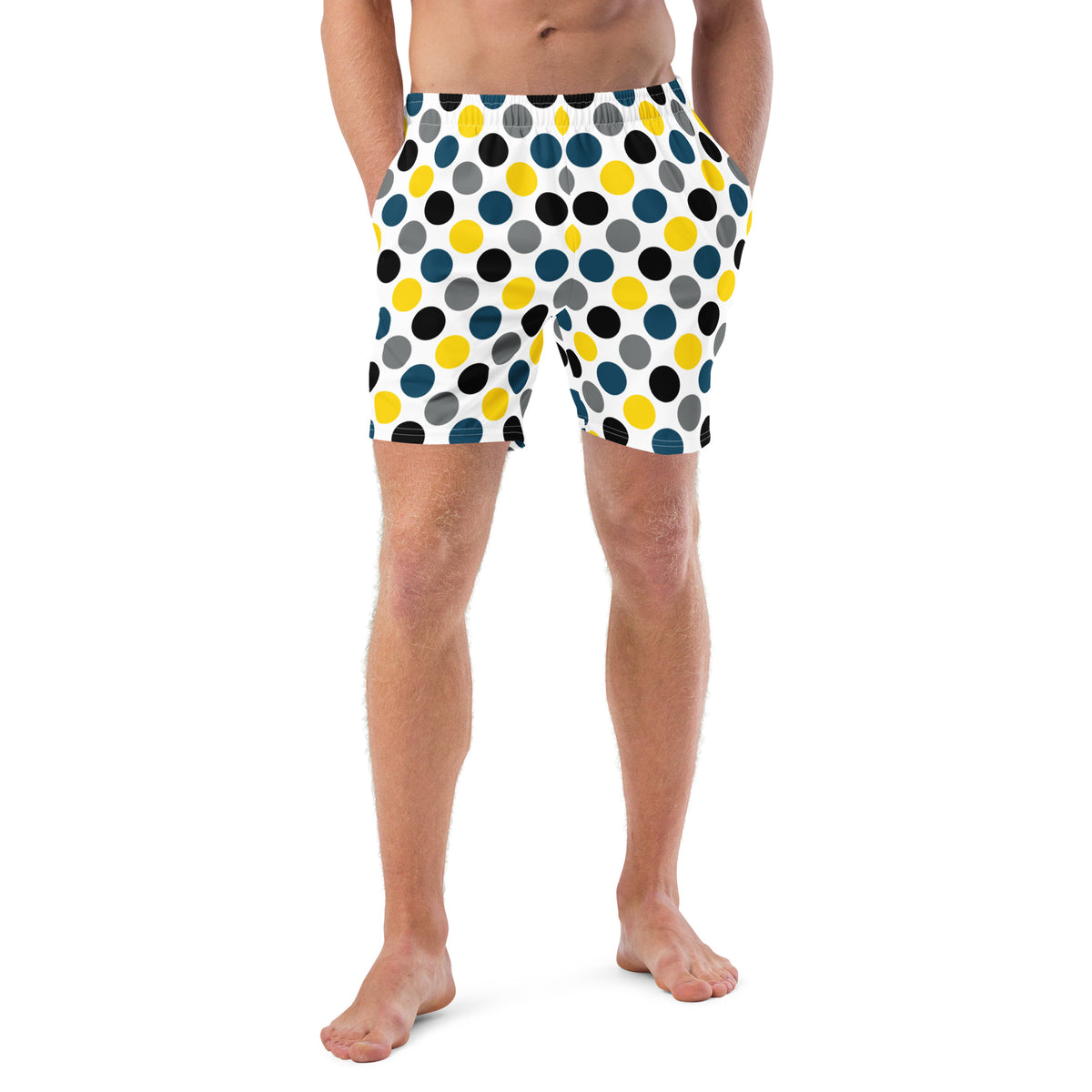 Polka dot swim trunks in white with blue, yellow, and black dots, mid-length