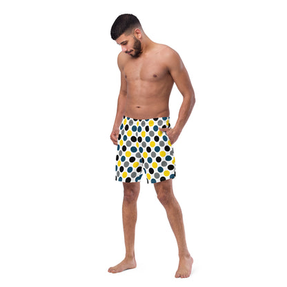 Front view polka dot swim trunks in white with blue, yellow, and black dots