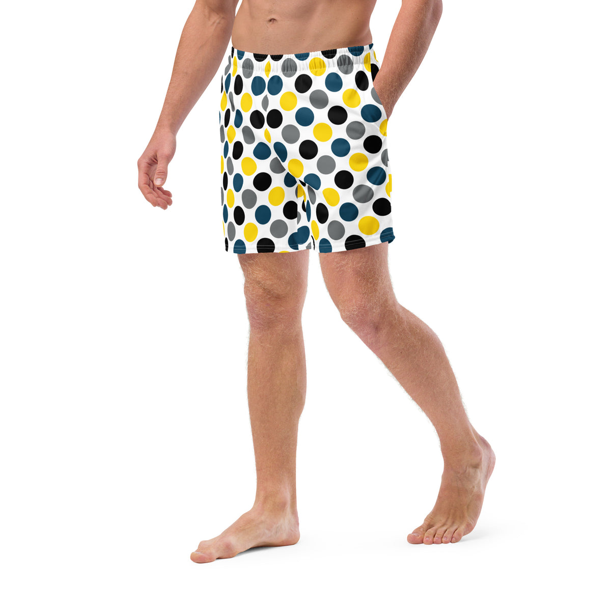 Side view polka dot swim trunks in white with blue, yellow, and black dots