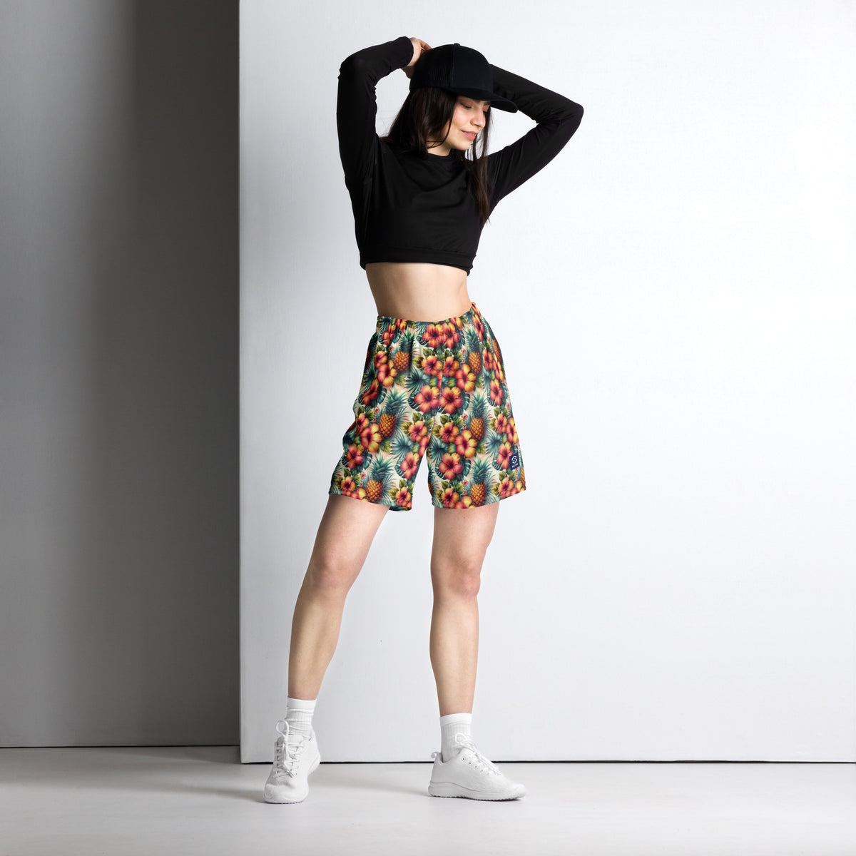 Tropical printed shorts with elastic waistband, worn mid-length, side pose