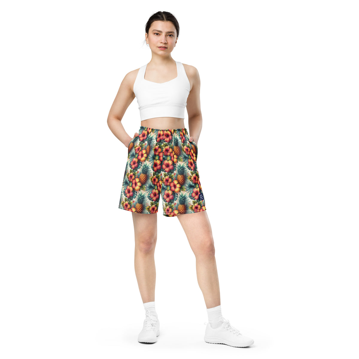 Tropical printed unisex shorts with elastic waistband and mid-thigh length, worn front view