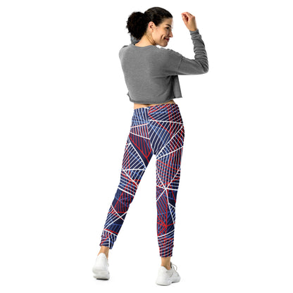 Women’s jogger pants with bold abstract line design on navy base and red-white details.