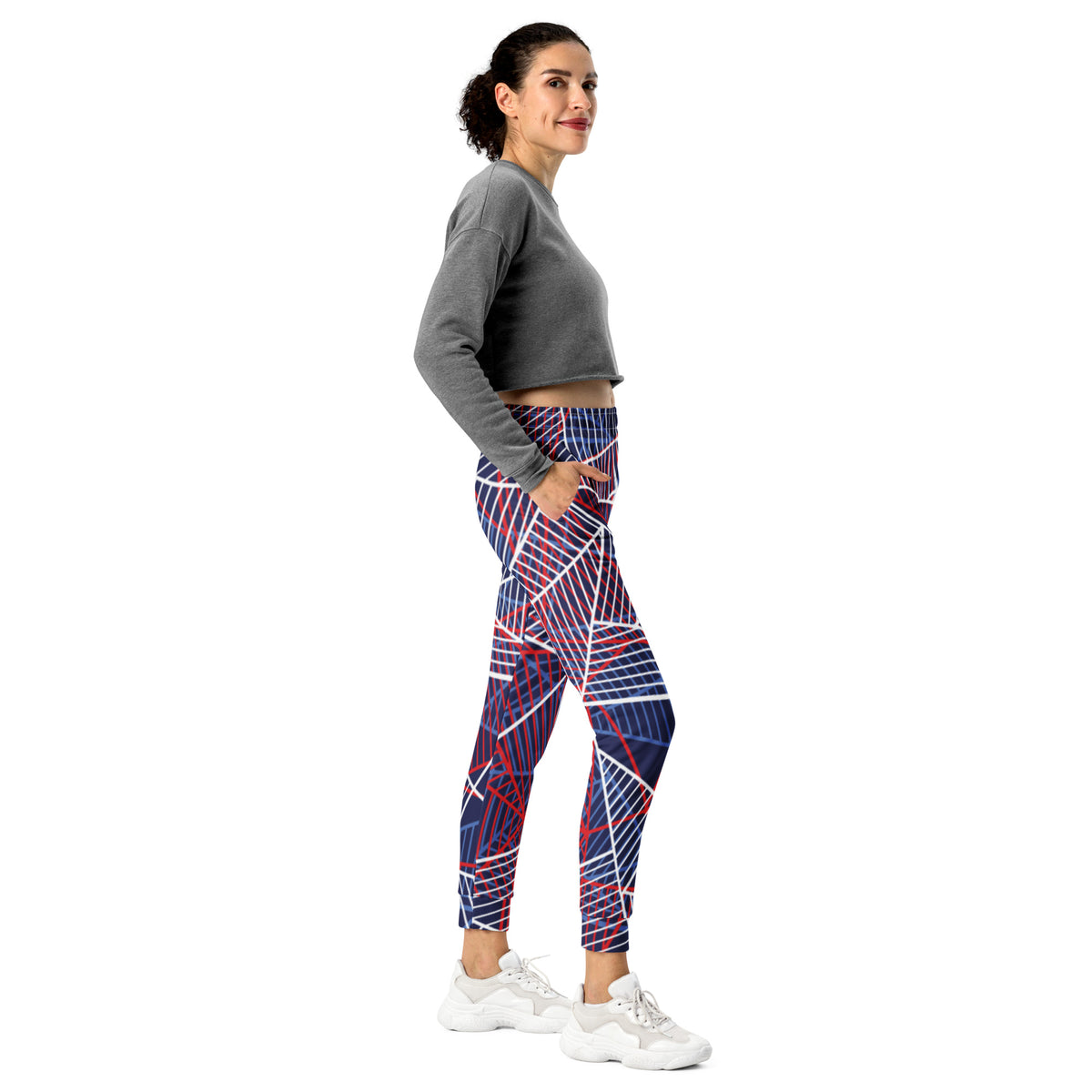 Women’s patterned joggers with abstract geometric lines on navy fabric and red accents.
