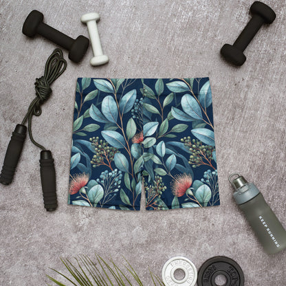 Botanic Garden shorts flat view, teal botanical print with blue leaves and red blooms