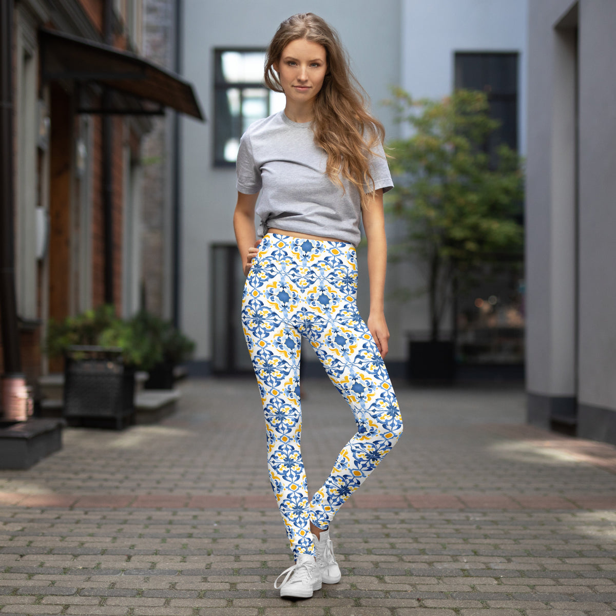 High-waist leggings with blue and white Moroccan tile floral print, full-length.