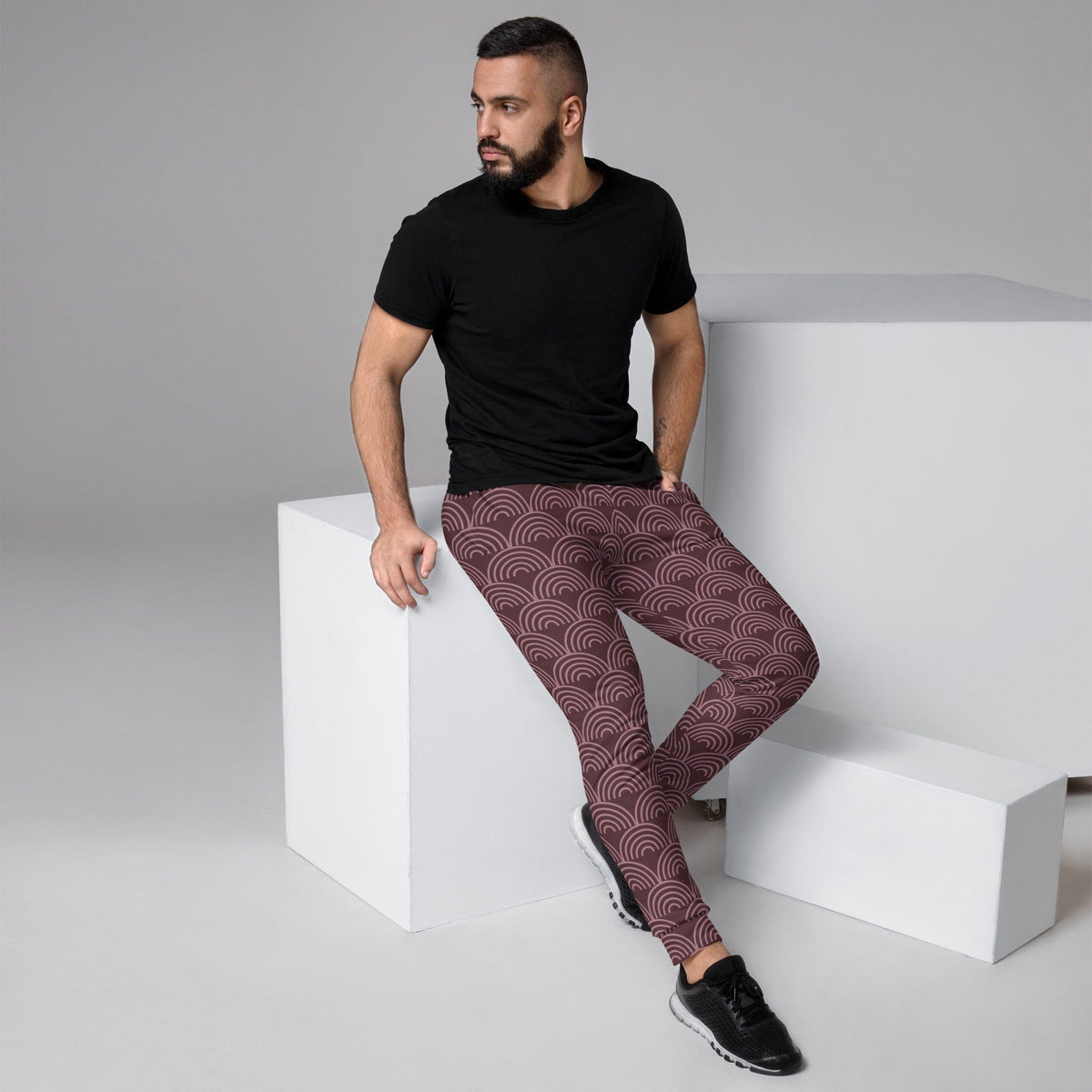 Men's joggers with maroon and dark semicircle wave print, shown in a side view.