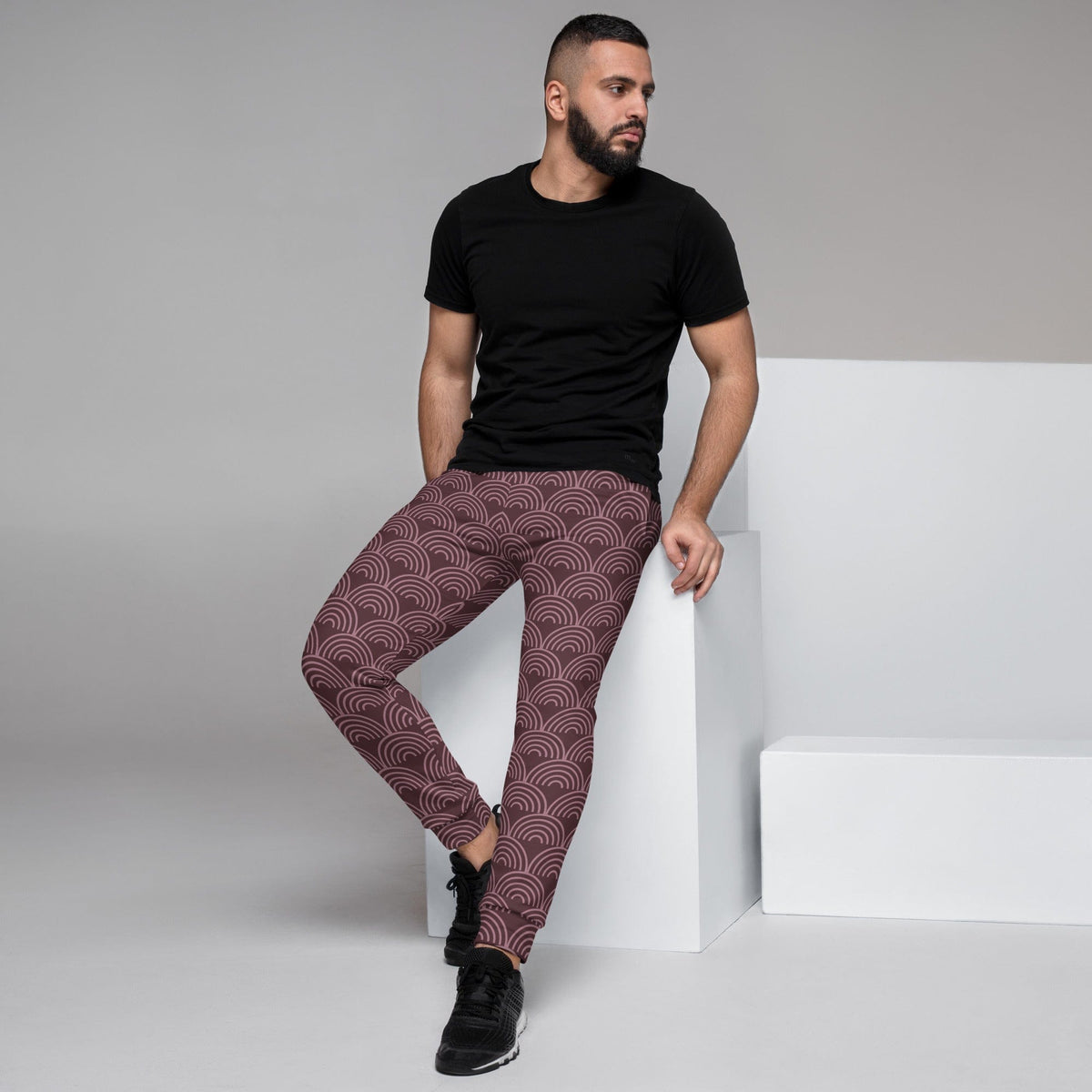 Men's joggers with allover maroon and dark semicircle wave print, slim tapered legs.