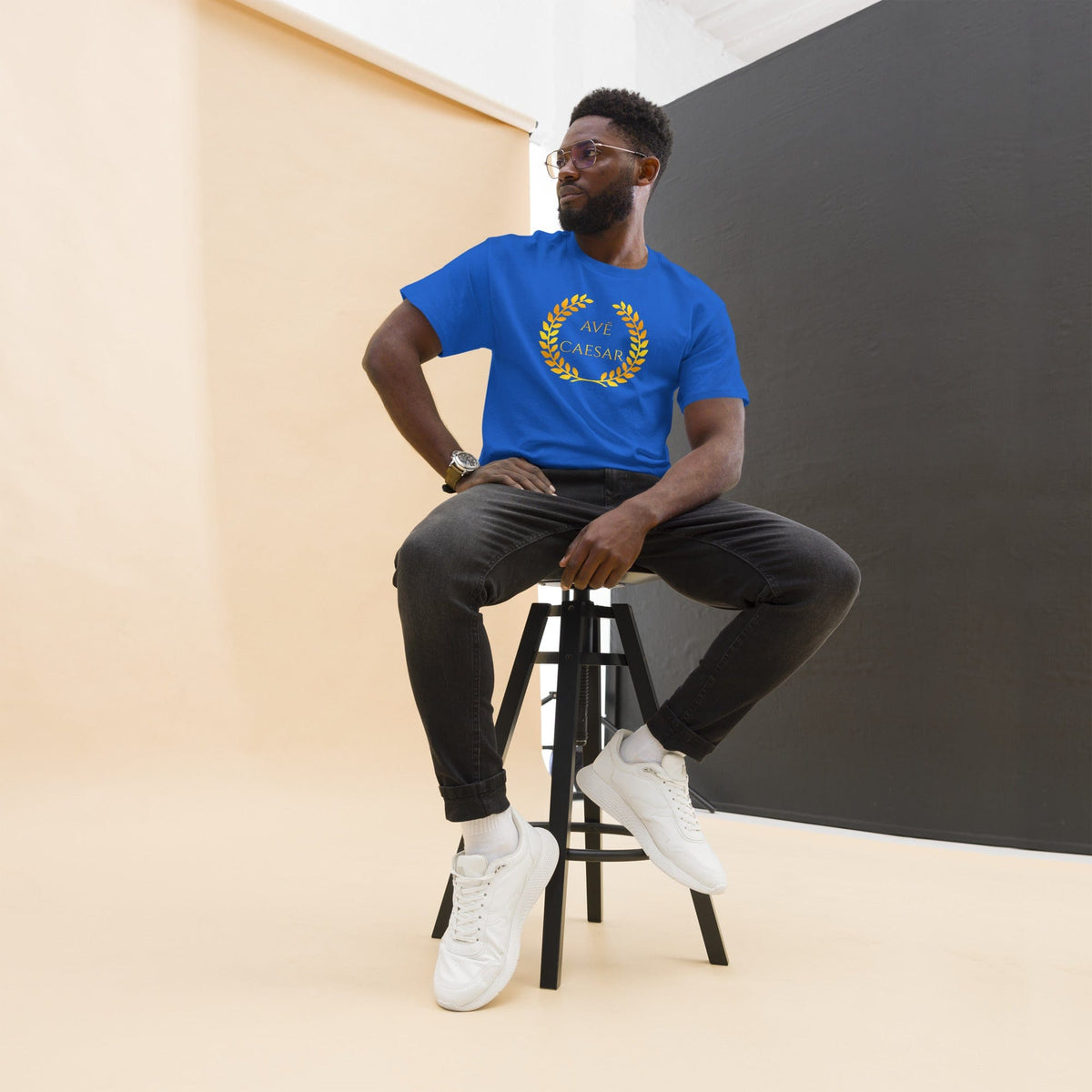 Blue T-shirt with small gold AVE CAESAR laurel logo on chest