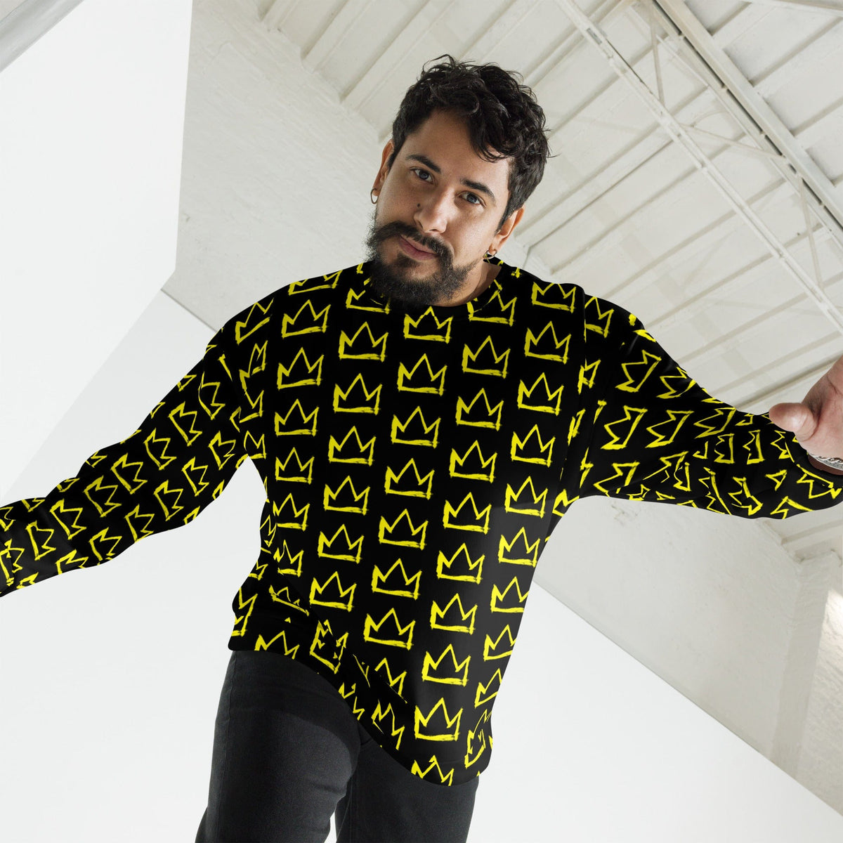 Black crewneck sweatshirt with repeating yellow crown pattern, long sleeves, arms out view