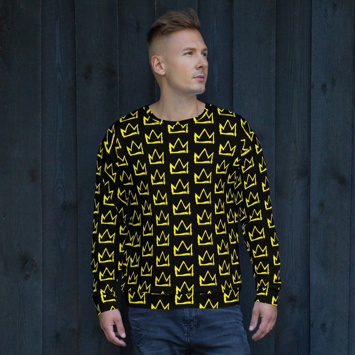 Black crewneck sweatshirt with repeating yellow crown pattern, long sleeves, side profile