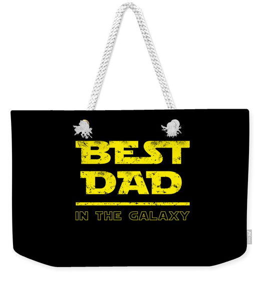 Black weekender tote bag with graphic 'Best Dad in the Galaxy' and light rope handles