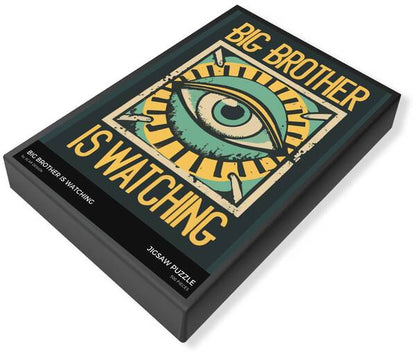 Jigsaw puzzle box lid with eye graphic and "BIG BROTHER IS WATCHING" text