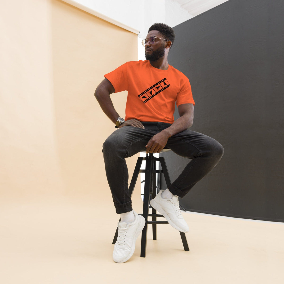 Orange Birds film strip T-shirt with black graphic print on the chest