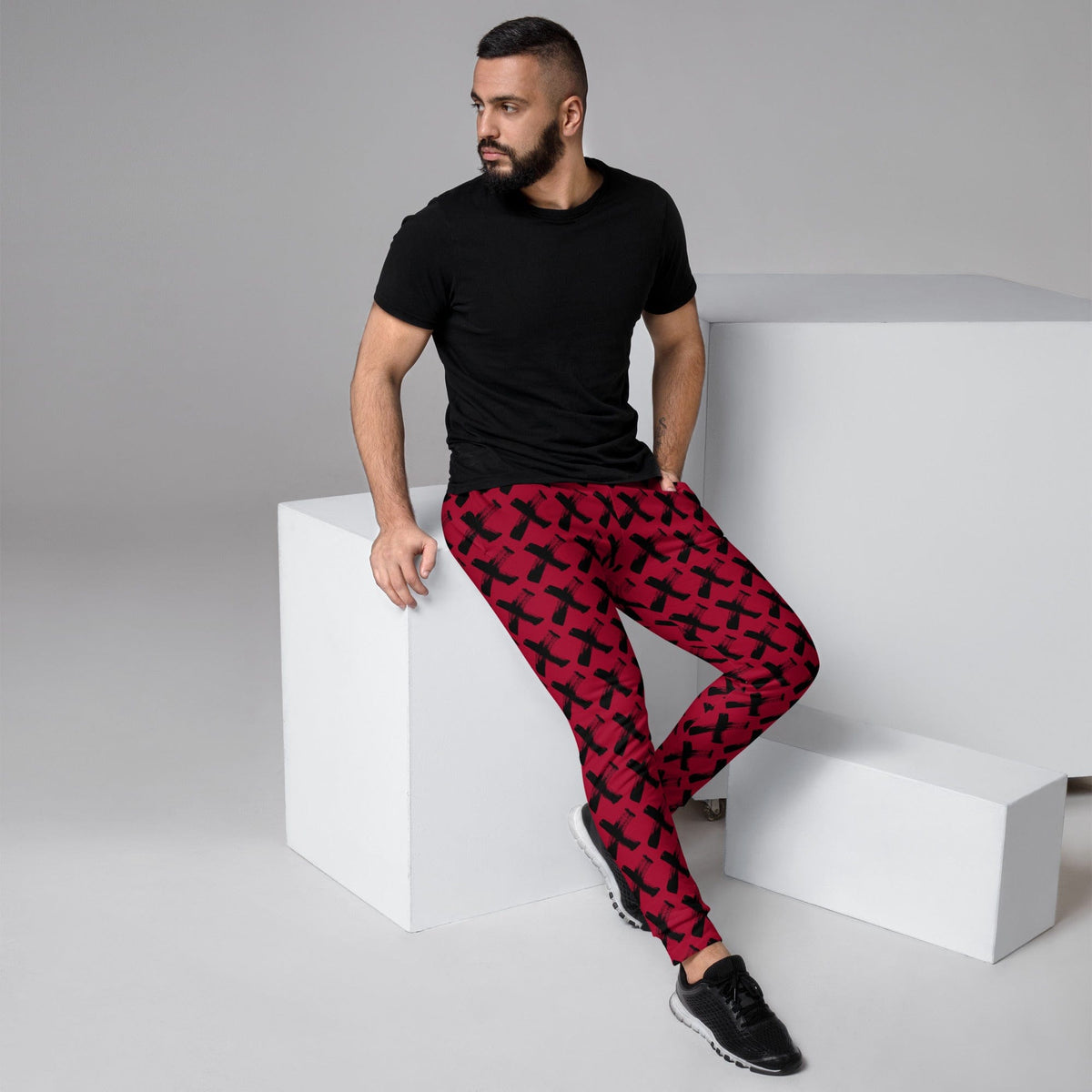 Men's red joggers with black X pattern, slim fit and elastic ankle cuffs