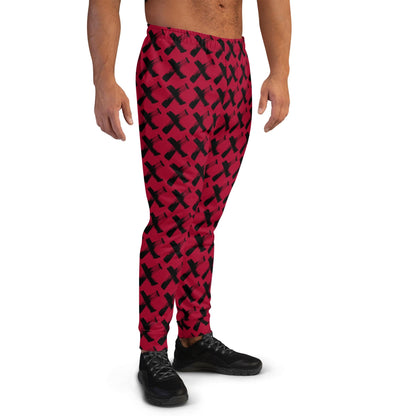 Men's red joggers with black X pattern, side view with elastic ankle cuffs