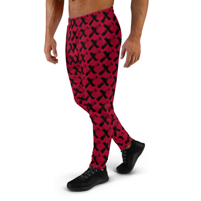 Men's red joggers with black X pattern, close side view of full-length legs