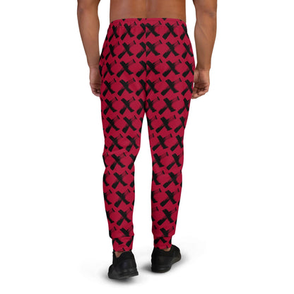 Men's red joggers with black X pattern, back view with elastic waistband and cuffs