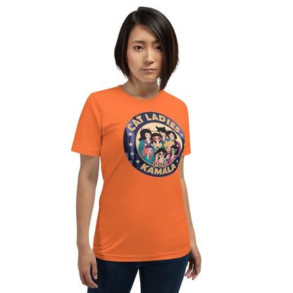 Orange T-shirt with round “CAT LADIES FOR KAMALA” cat graphic on the chest
