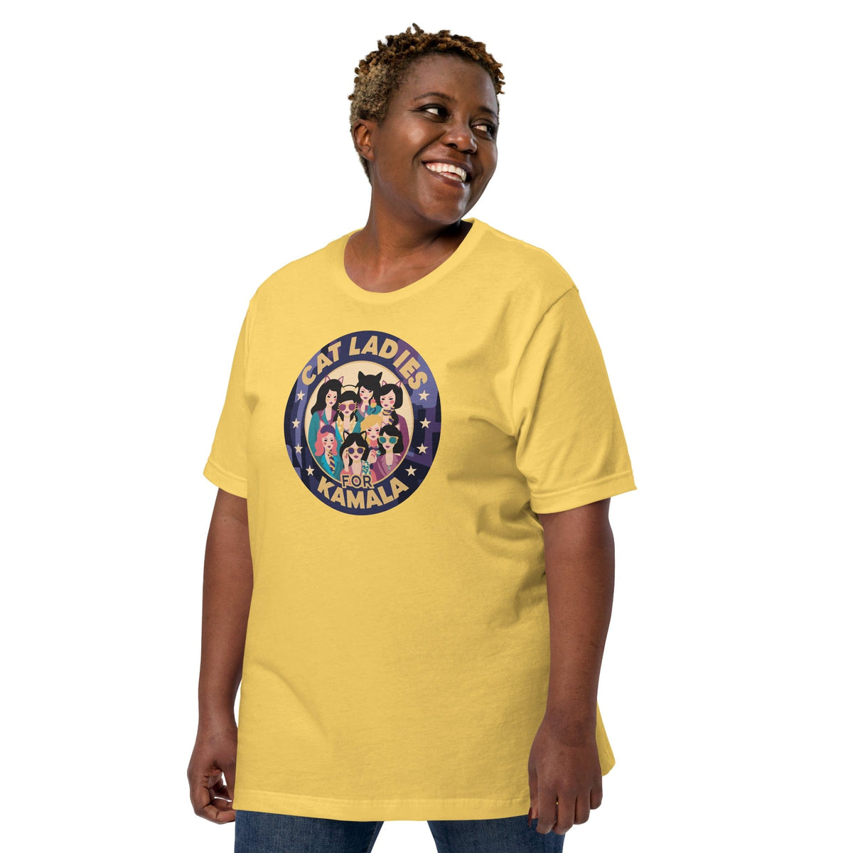 Yellow T-shirt with round “CAT LADIES FOR KAMALA” cat graphic on the chest