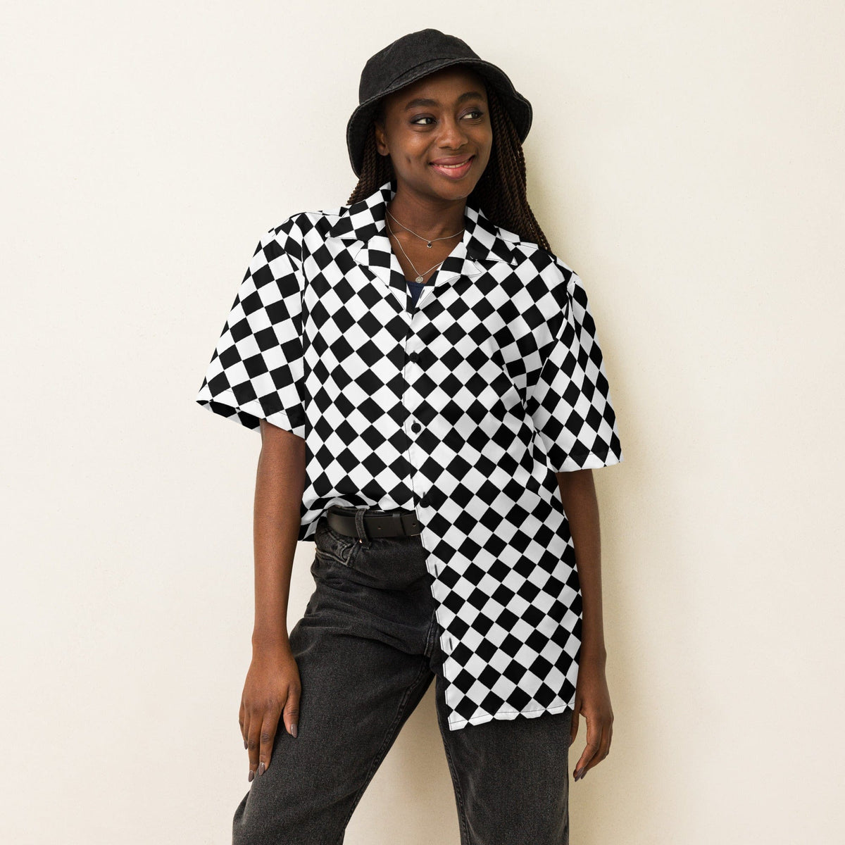 Unisex black-and-white chessboard button shirt with short sleeves, worn with open collar.