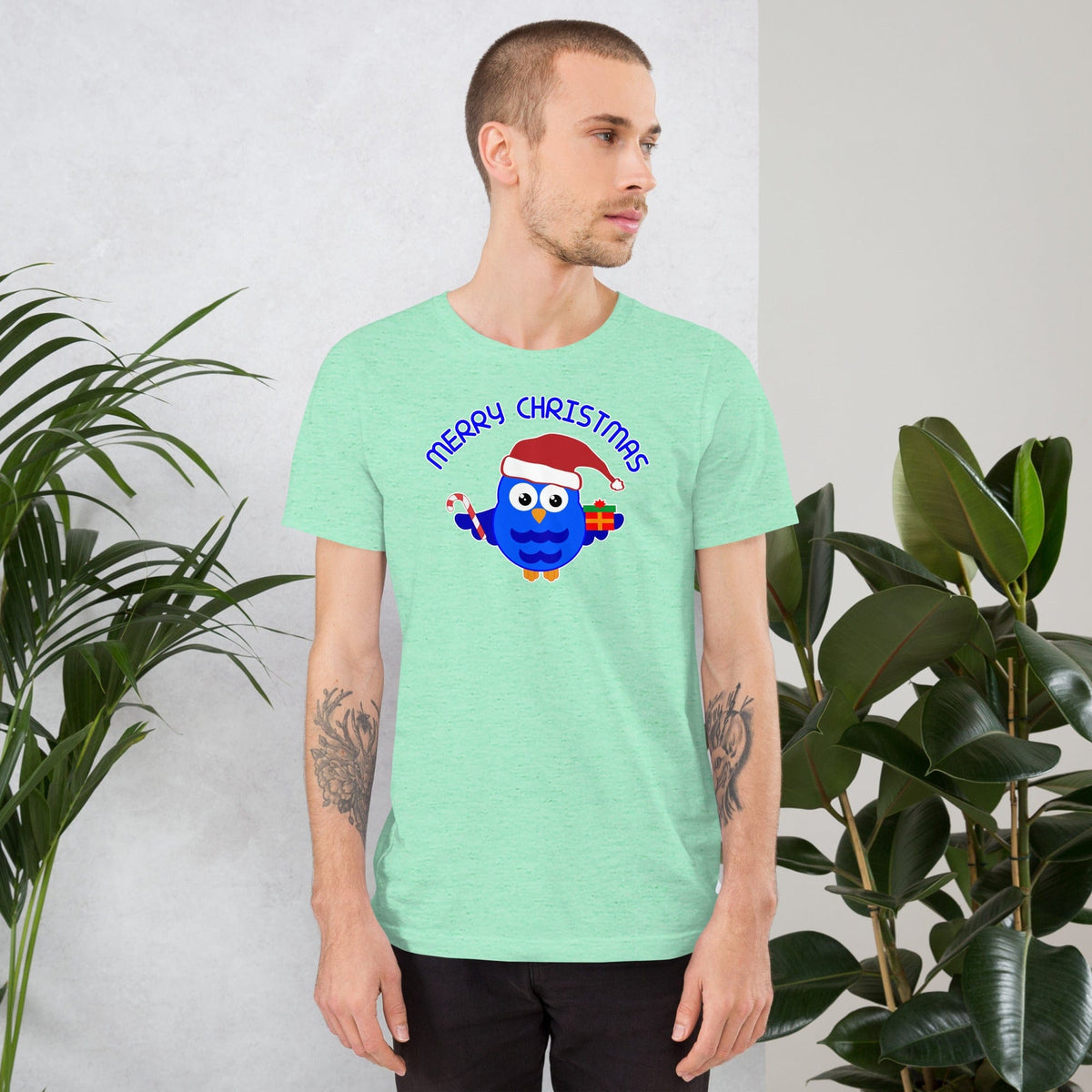 Christmas owl graphic T-shirt in mint green with blue cartoon owl and “Merry Christmas” text.