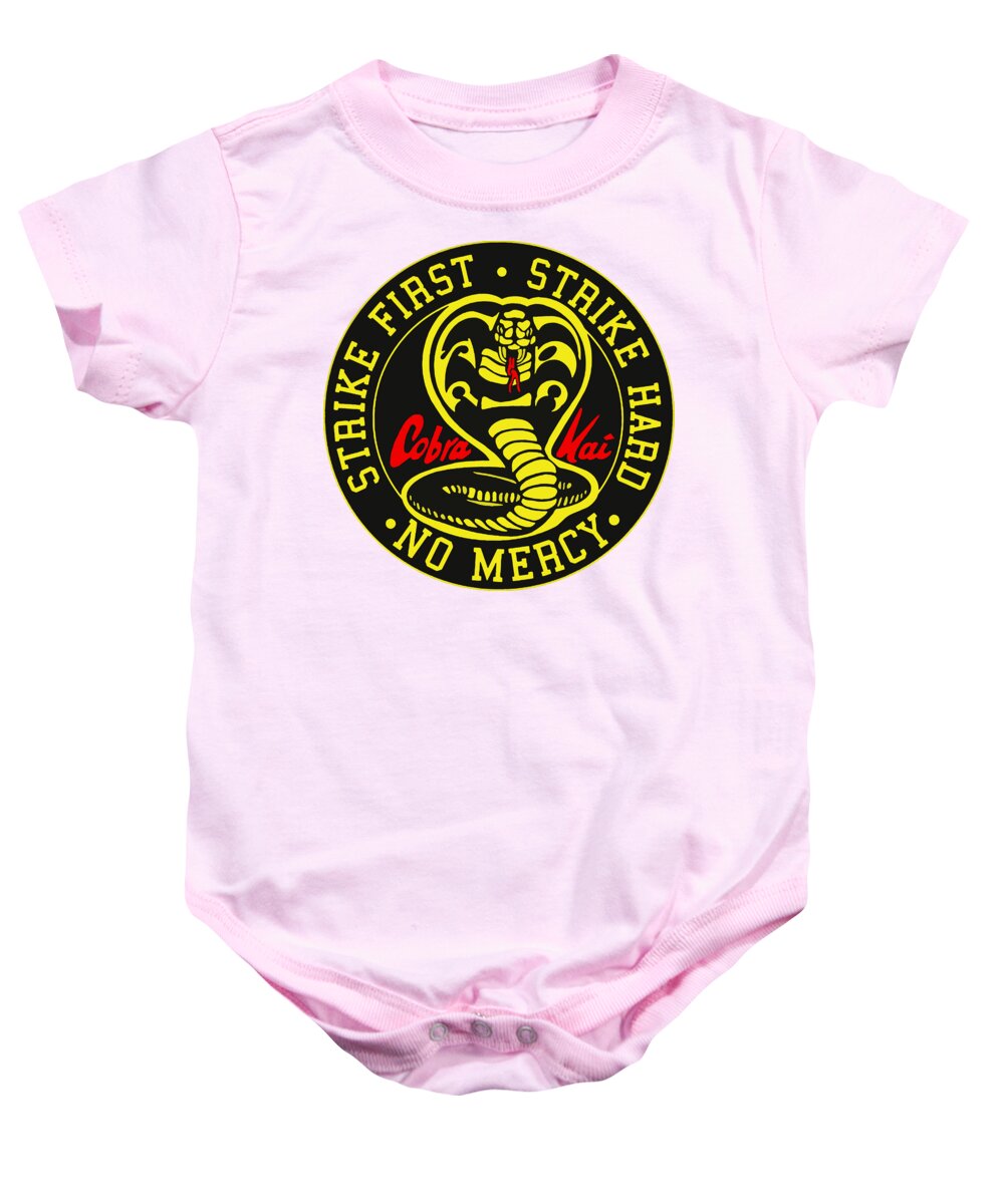 Light pink baby onesie with short sleeves, snap-button legs, and round karate logo graphic