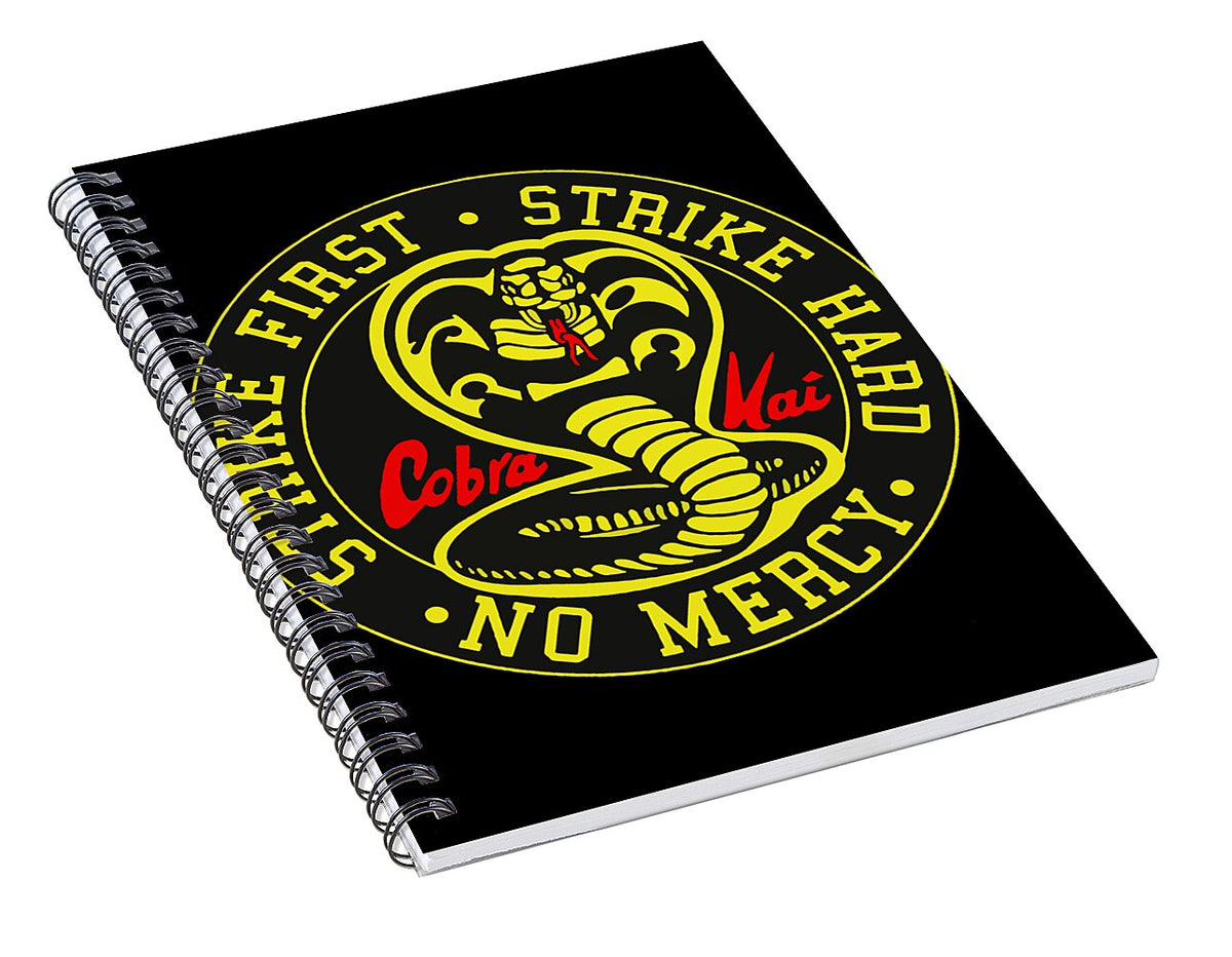 Black spiral notebook with Cobra Kai 'Strike First' 'No Mercy' logo on cover