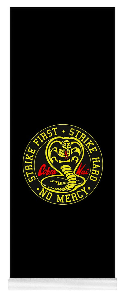 Black yoga mat with Cobra Kai circular logo and slogan near the bottom
