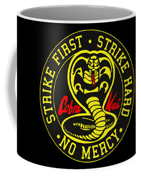 Black mug with yellow cobra emblem and 'STRIKE FIRST' text