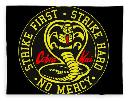Black throw blanket with centered yellow emblem, coiled cobra graphic, and red text