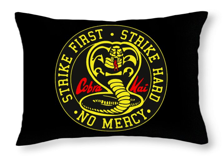 Black throw pillow featuring circular Cobra Kai emblem and “Strike First” text
