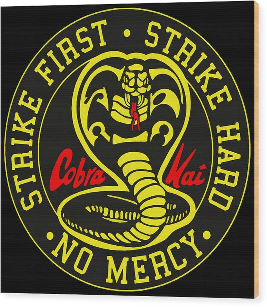 Wood print with circular cobra emblem and yellow text on dark background.