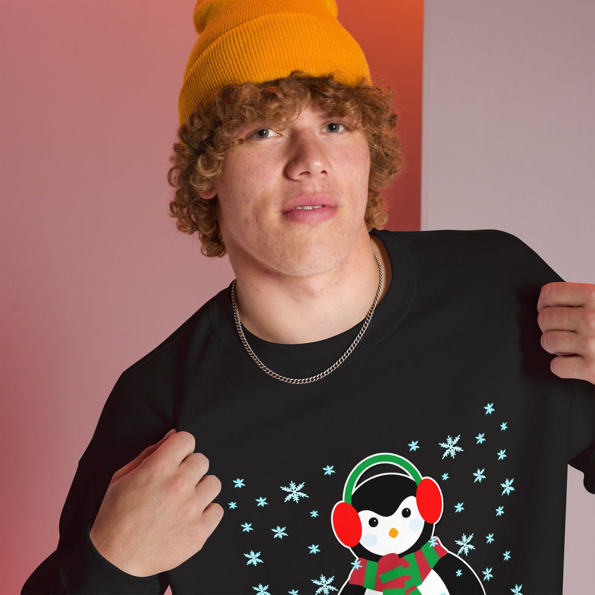 Black crewneck sweatshirt with long sleeves and a penguin graphic with snowflakes
