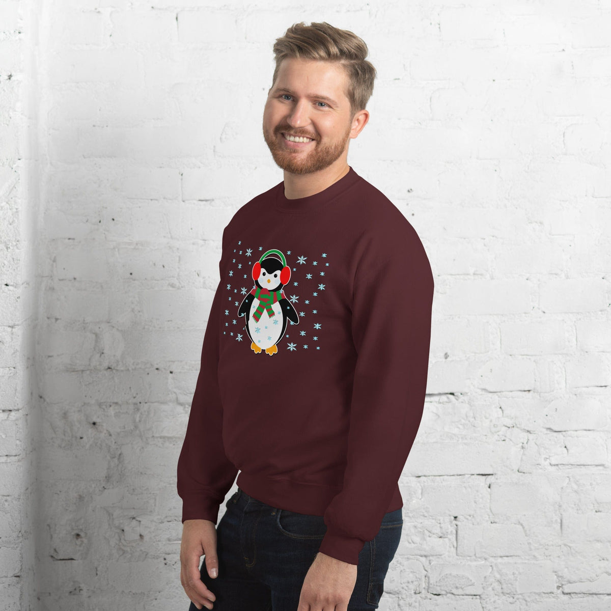 Maroon crewneck sweatshirt with long sleeves and a penguin graphic with snowflakes