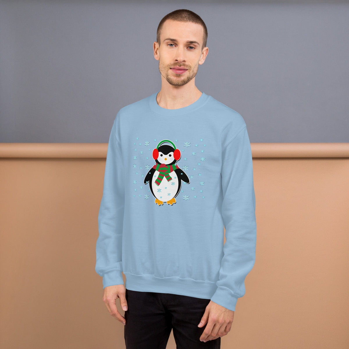 Light blue crewneck sweatshirt with long sleeves and a penguin graphic with snowflakes