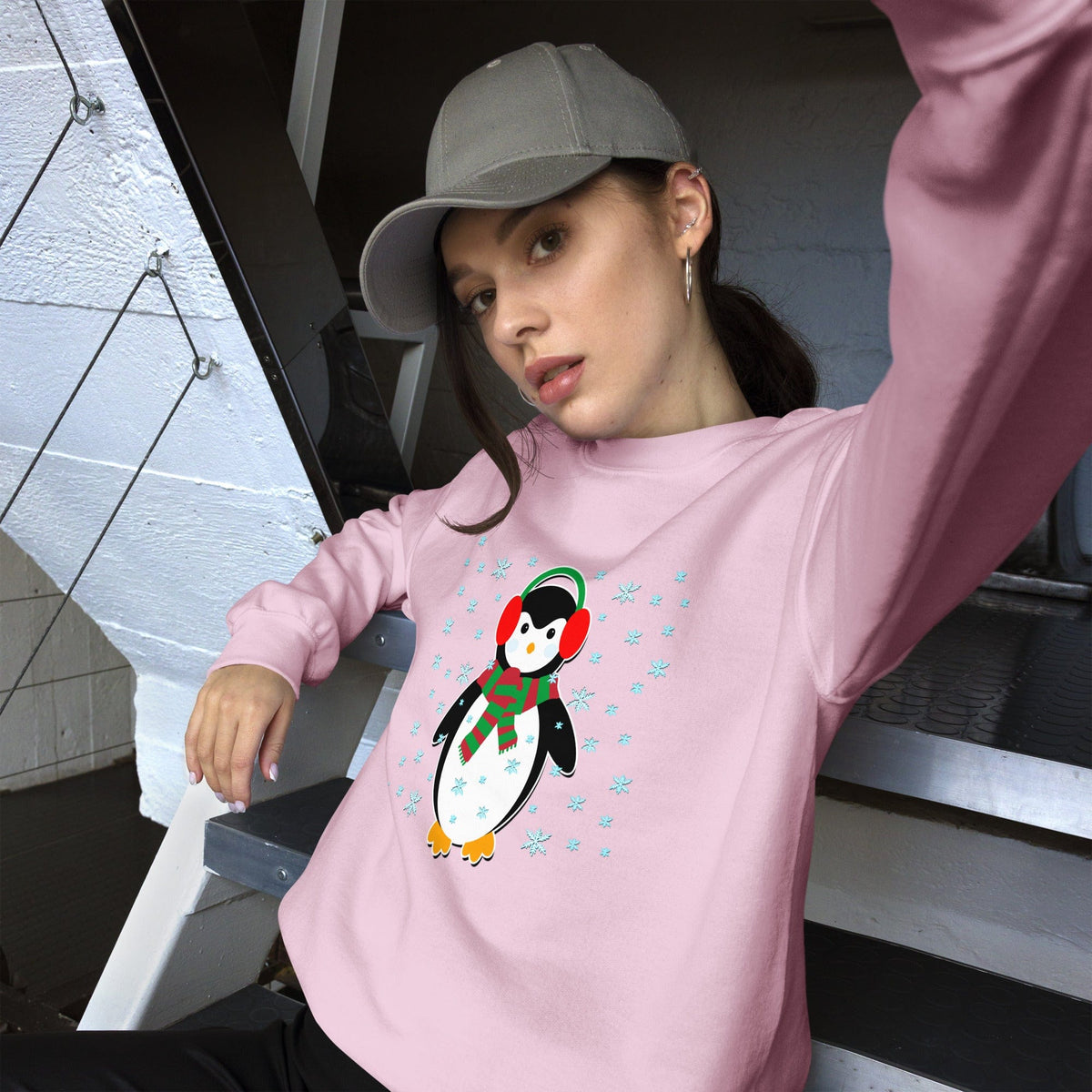 Light pink sweatshirt with long sleeves and a colorful penguin graphic on the front.