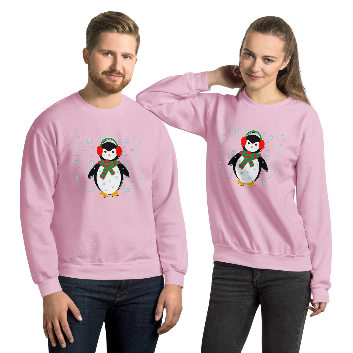 Light pink crewneck sweatshirt with long sleeves and a penguin graphic with snowflakes