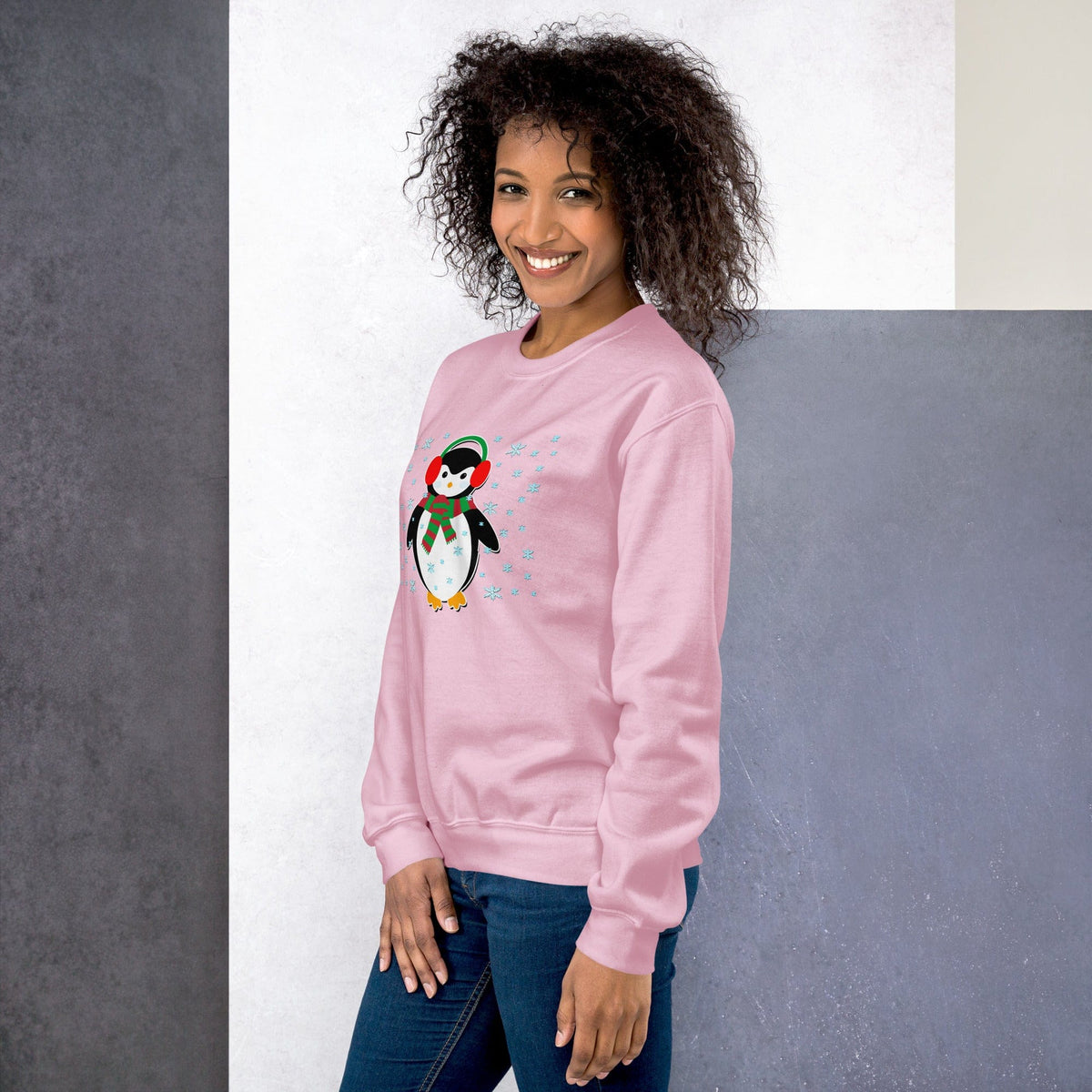 Light pink crewneck sweatshirt with long sleeves and a penguin graphic printed on the front.