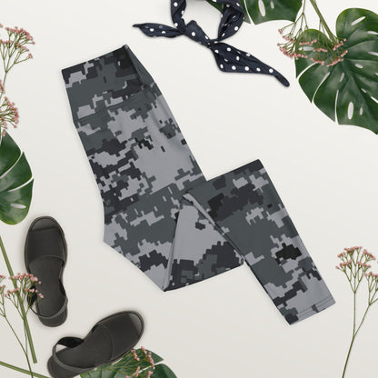 Digital camo yoga leggings laid flat, dark gray pixel print, folded waistband
