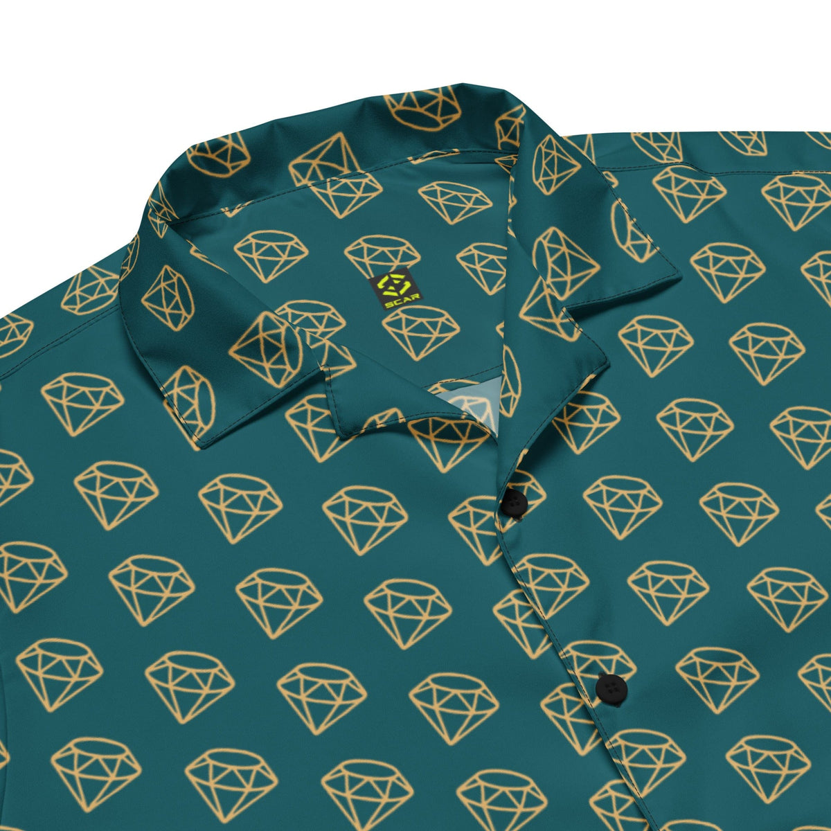 Dark teal button-up shirt fabric close-up with gold diamond pattern and black button