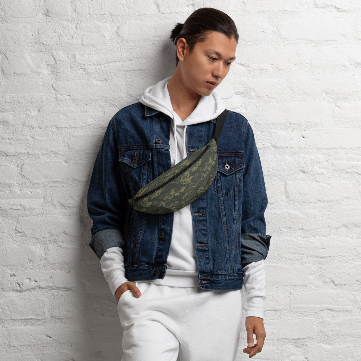 Camouflage waist bag across chest on person wearing a denim jacket