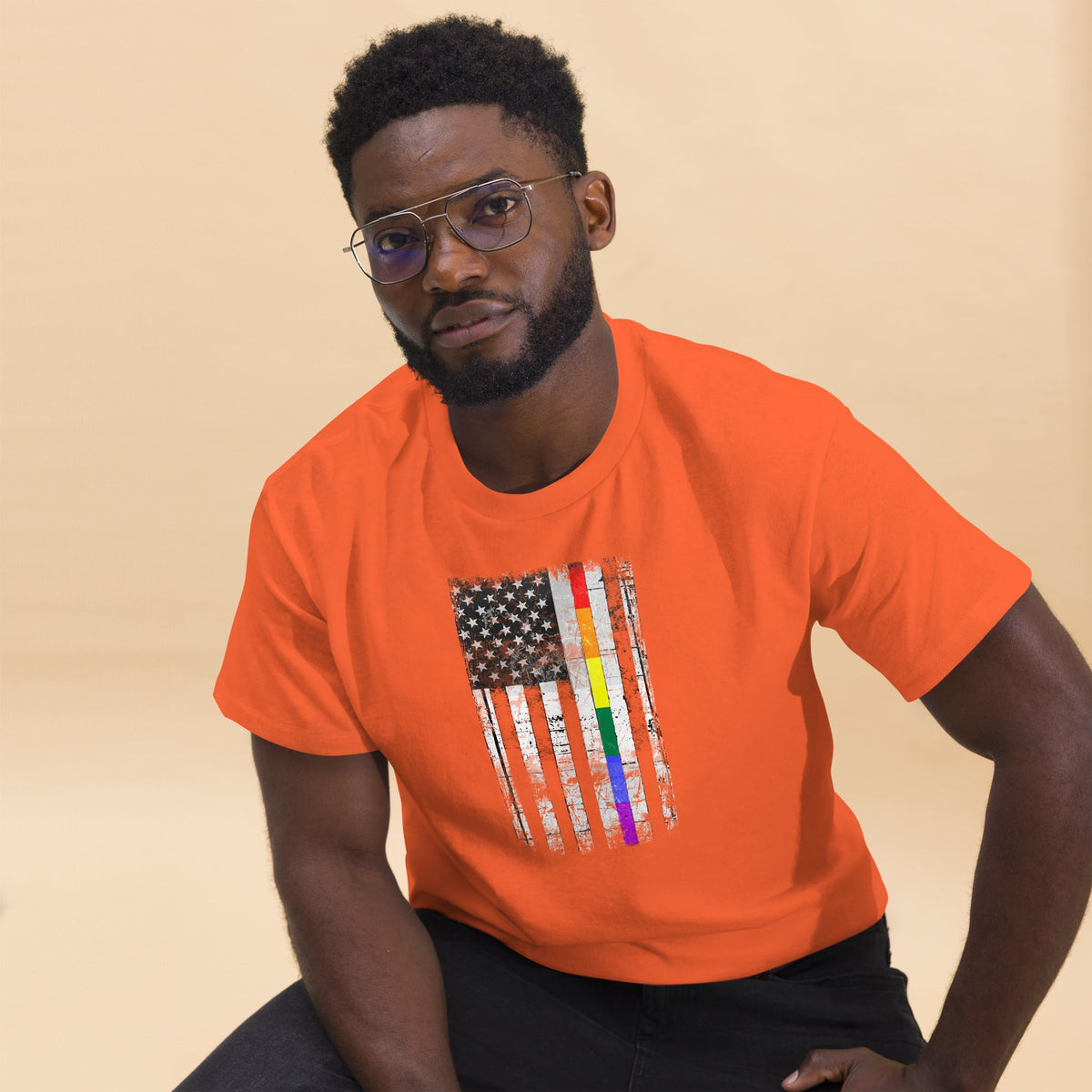 Orange T-shirt with distressed rainbow-striped American flag graphic on the chest