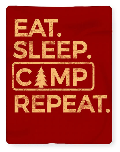 Red blanket showing gold “EAT. SLEEP CAMP REPEAT.” graphic print.