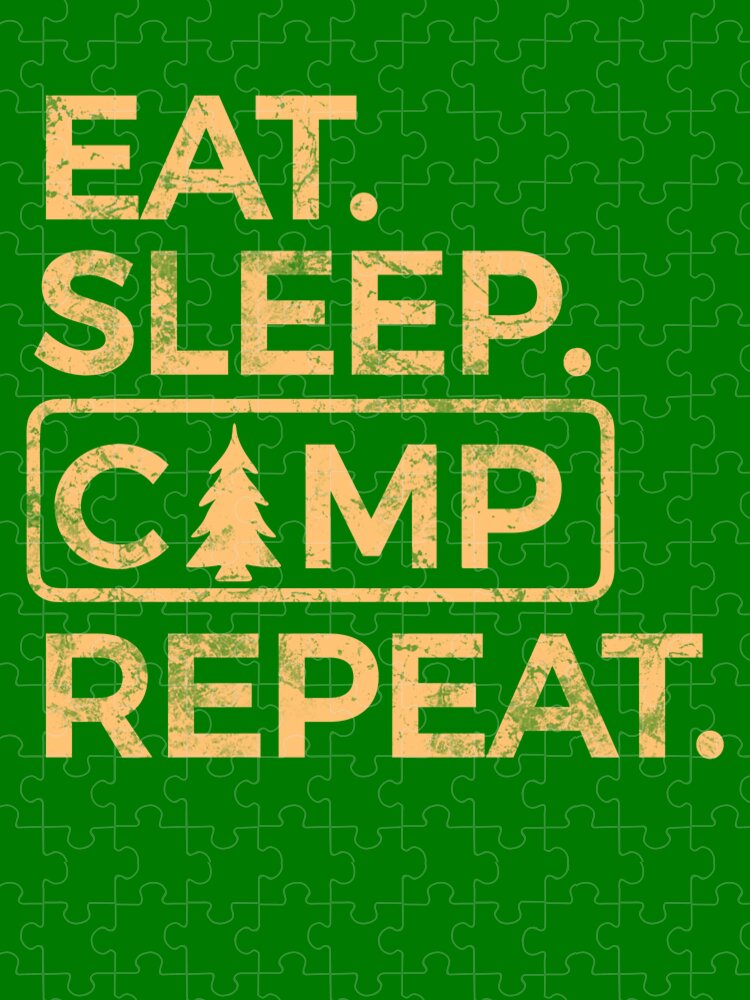Green jigsaw puzzle showing EAT. SLEEP. CAMP REPEAT. and pine tree