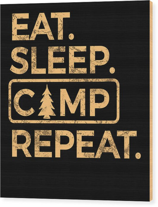 Dark wood wall print with beige text: EAT. SLEEP. CAMP REPEAT, with pine tree icon.