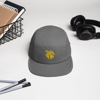Grey five-panel cap with embroidered yellow raven emblem on the front